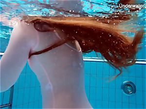 red-haired Simonna flashing her bod underwater